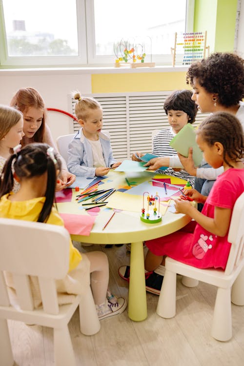 Free Children Sitting on Chairs in Front of Table With Art Materials Stock Photo